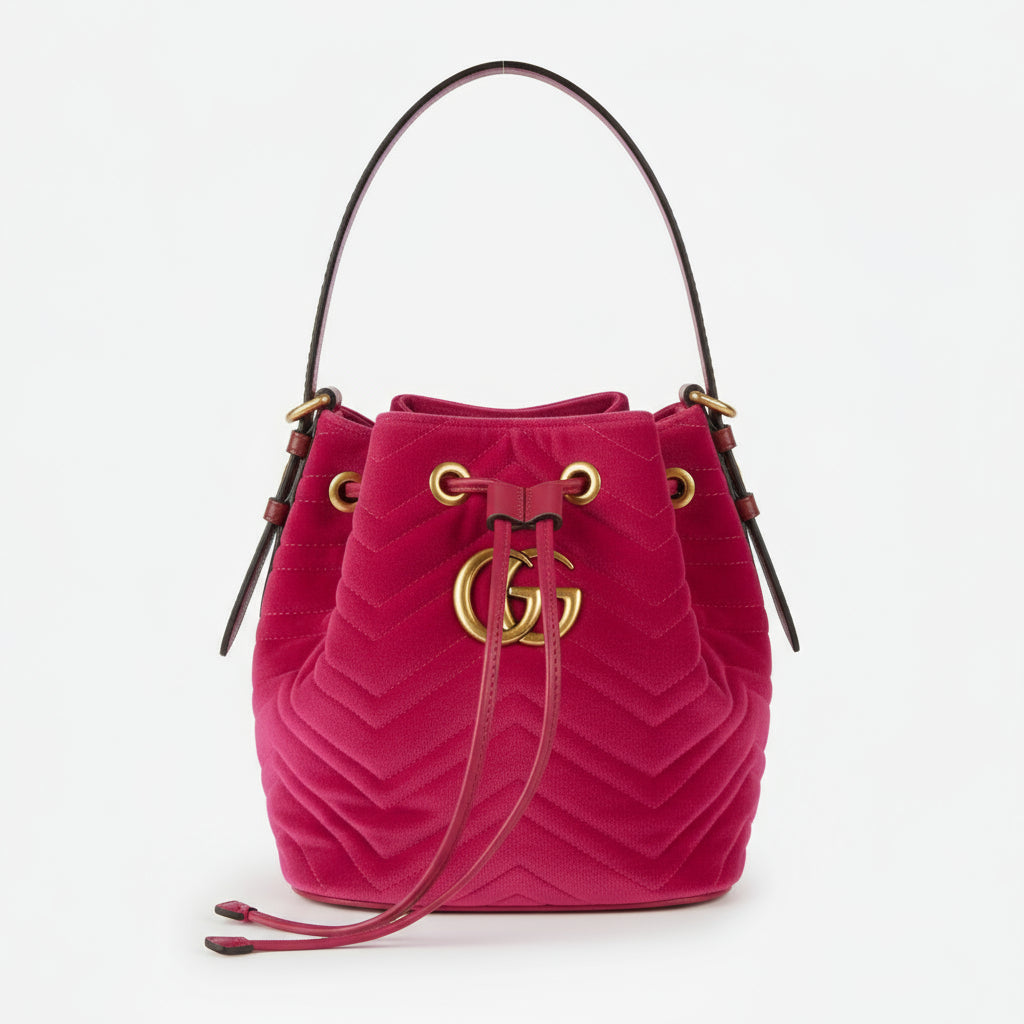 Red velvet handbag with gold accents on a white background